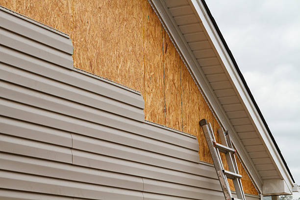 Professional Storm Damage Siding Repair technician working in Spartansburg, PA